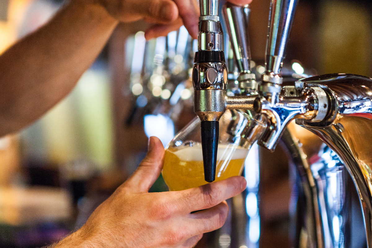 Bartender pouring a craft beer from tap handles