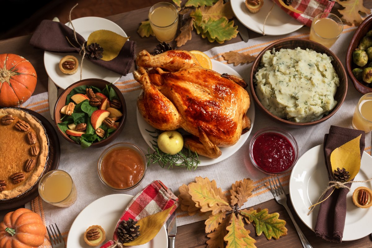 Thanksgiving buffet table with roast turkey, sides and pie